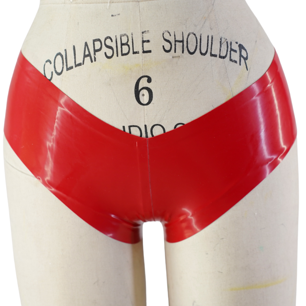 Latex Fashion by Vex A dress form mannequin labeled Collapsible Shoulder 6 displays shiny red high-waisted latex Boy Shorts underwear.