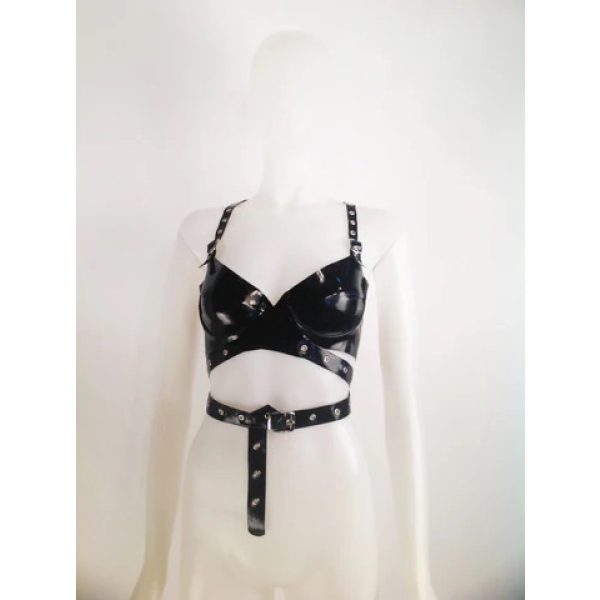 Latex Fashion by Vex A mannequin wears the Wrap Ride On Bra, a black faux leather harness top with metal studs, adjustable straps, and a waist belt detail, set against a plain white background.